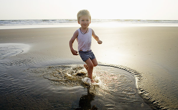 Photograph of a child playing on the beach