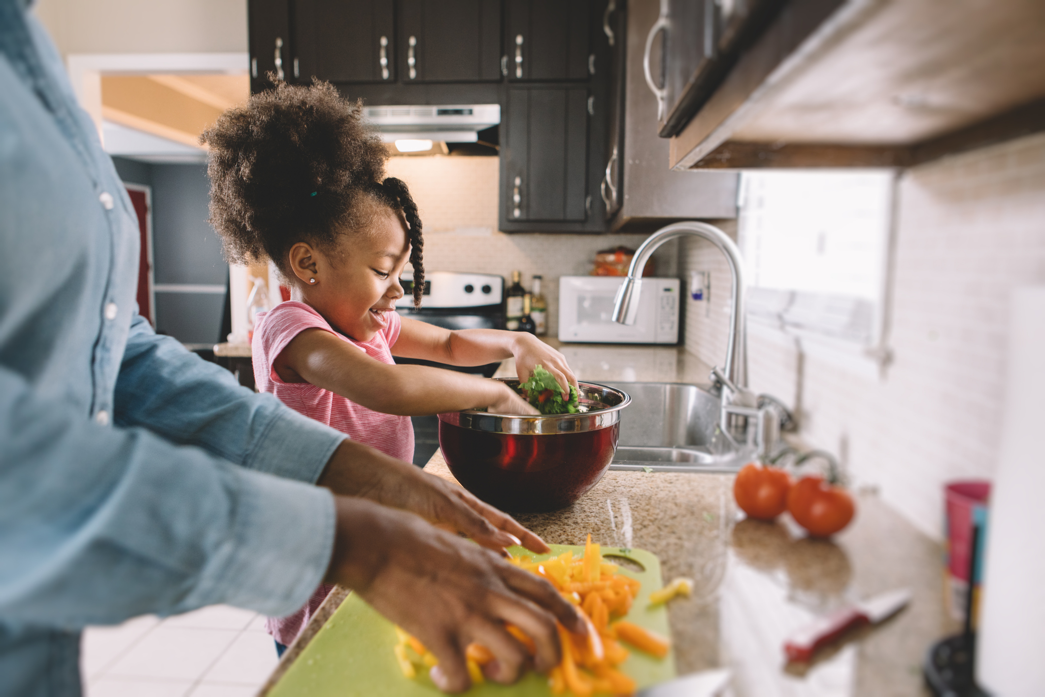 Photo of mom and daughter making salad